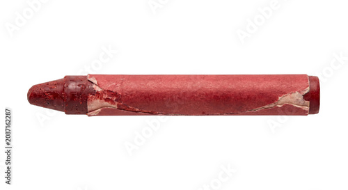 Konstfotografi Close-up of a used red crayon with torn paper wrapper on a white background
