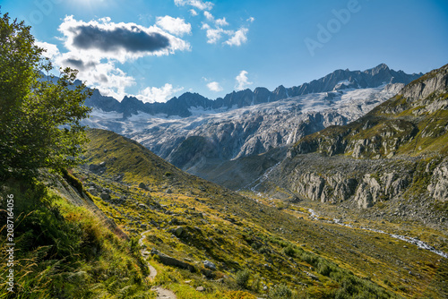 Trail through a rugged glacial valley with a stream