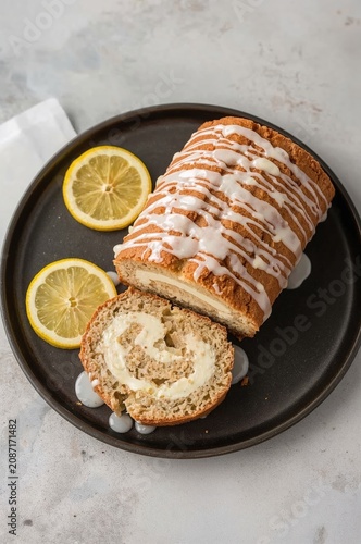 Baked Dessert With Glaze and Lemon Slices on a Dark Plate