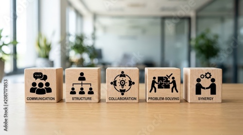 Wooden blocks with business concept icons for communication structure collaboration problem solving and synergy on a wooden desk in office