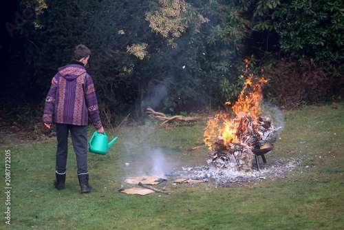 A young man is holding a box that is on fire
