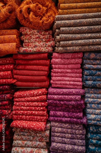 Bright Colors of Fabric Stacked Neatly in a Store Display During the Day