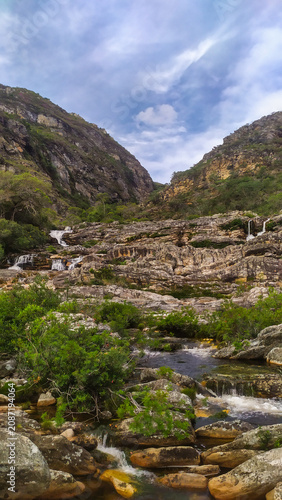 Crystal-clear waterfalls flow through the rugged mountains of the Espinhaço Range, revealing the natural beauty of Minas Gerais, Brazil.