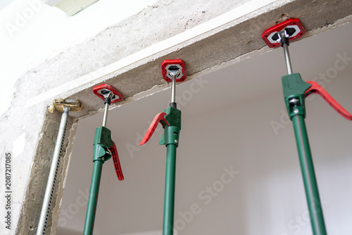 Canvas Print Temporary construction shoring system with adjustable steel props supporting a l