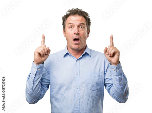 Surprised man pointing both fingers up isolated on transparent background