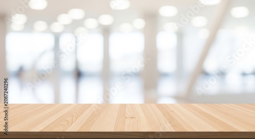 Empty wooden table top with blurred modern office background