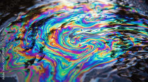 Bright colors swirl in water as light reflects off the surface