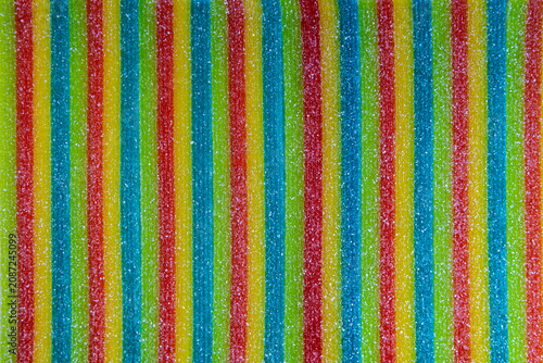 Fotografie Rainbow sour candy strips with granulated sugar texture pattern