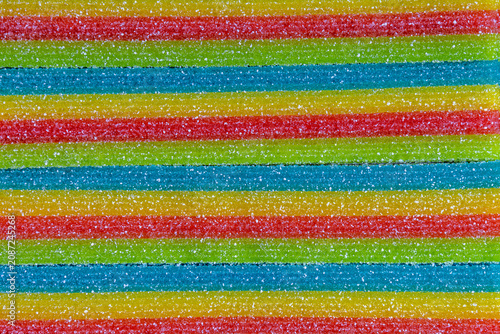 Rainbow sugar candy strips texture colorful sweet confectionery background