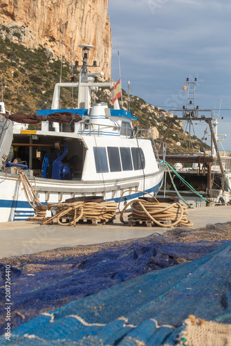 Fishing boats and nets by the Calpe cliff in Spain