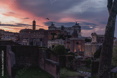 Canvas Print Ancient Roman Forum ruins at sunset with dramatic purple and pink sky, silhouett