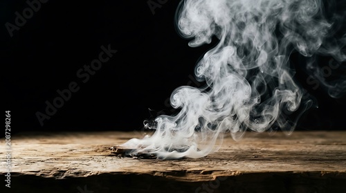 Wisps of white smoke rising from a smoldering ember on a rustic wooden surface against a dark background