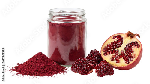 Pomegranate seeds and juice in glass jar