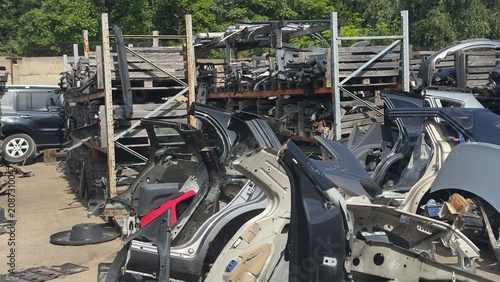 Fotografie Scrapyard filled with burnt car frames and wrecked metal parts