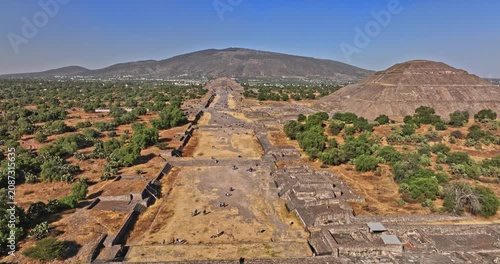 Teotihuacan Mexico Aerial v8 low level flyover and around archaeological site, panning above avenue of the dead capturing historic pyramid and temple - Shot with Mavic 3 Cine - December 2021