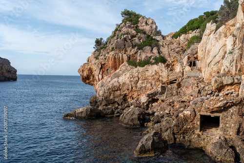Rocky coastal cliffs and traditional fishermen shelters by the sea