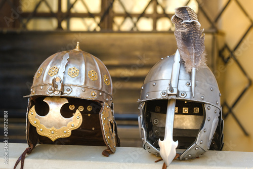 Bild auf Leinwand Two knight's helmets are lying on the surface.Medieval concept