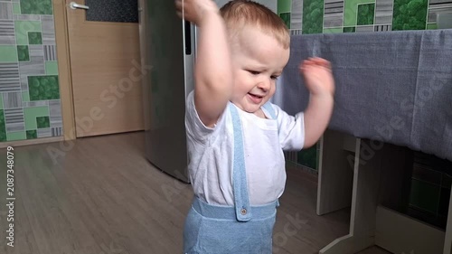 Adorable little boy dancing happily at home