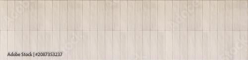 Taupe ceramic finger tiles in a seamless vertical linear stack layout