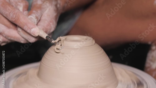 Potter Trimming Clay Bowl On Pottery Wheel Close Up