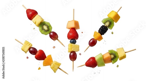 Vibrant Assorted Fruit Skewers with Strawberry Kiwi Pineapple and Grape Flying in Mid Air Isolated on White Backdrop