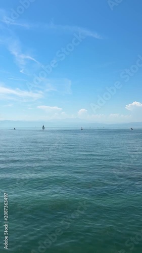 Friedrichshafen, Germany - June 27, 2026: Ferries, leisure boats, paddleboards and other watercraft move across Lake Constance during a clear summer day along the waterfront.