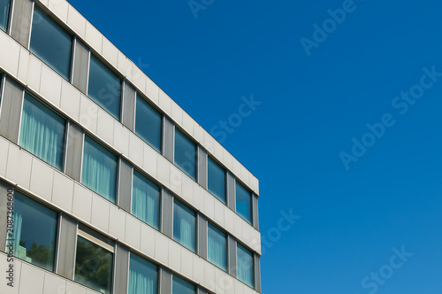 Canvas Print Modern hospital building facade under a clear blue sky in Lugano