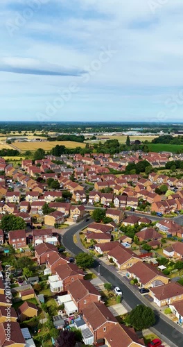 Portrait vertical footage of the market town of Pocklington near York in the East Riding of Yorkshire showing modern residential housing estates quiet suburban streets and surrounding farmland