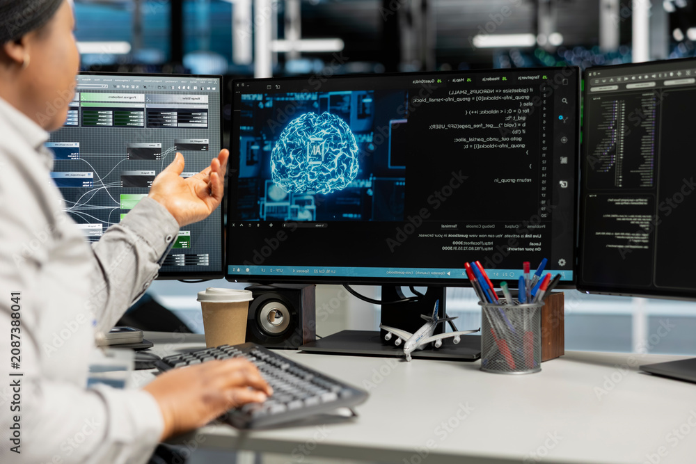 Fototapeta premium Data center expert applying AI technology to reduce downtime. African American professional at work designs and implements AI driven solutions for server facility equipment.