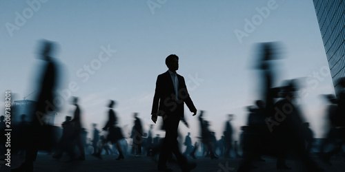 AI workflow concept with executive silhouette walking through a blurred corporate crowd