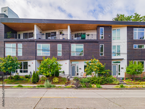 Modern multi-unit residential building with wooden facade and balconies