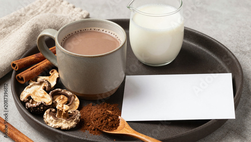 Mushroom cocoa beverage prep with ceramic mug and recipe card