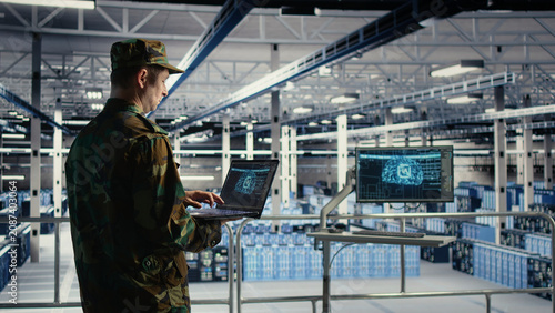 Fotografie Army commander uses AI tools in a server room to manage secure military computer systems