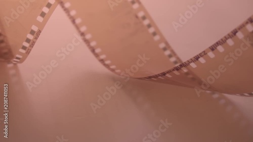  35mm negative photographic film in rotation .Slightly rolled film strip Analog film strips. Analog photography. Close-up. 