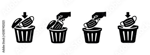 Картината върху платно Discarding used face masks into a trash bin, a symbol of hygiene and waste manag
