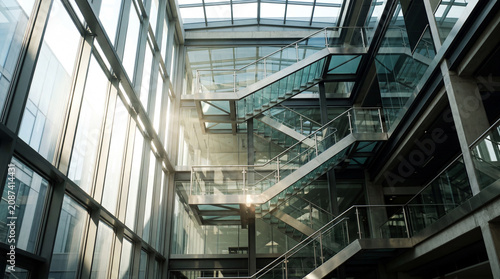Bright Sunlight Piercing Through Modern Glass Stairwell Atrium Inside Luxury Commercial Office Building Architecture Interior