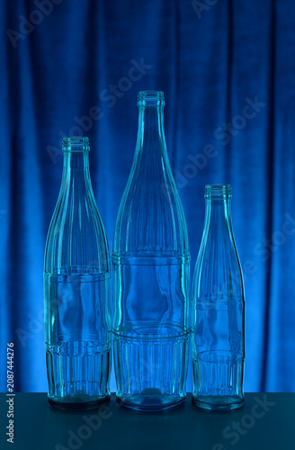 Backlit blue glass bottles