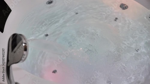 Bathing in a jacuzzi.Bubbling water in a jacuzzi with changing lighting. 4k footage