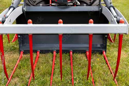 Bild auf Leinwand Crocodile grapple with long metal tines mounted on tractor loader for manure and