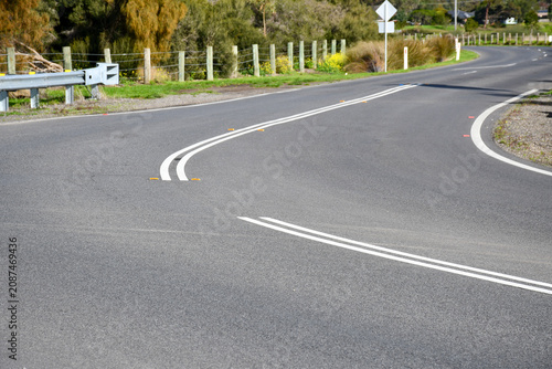 Фотография curving road with double lines for no overtaking