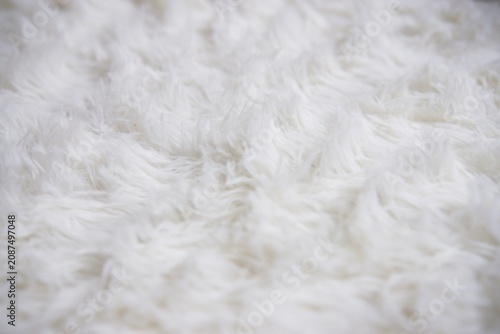 A close-up shot of a white rug or white carpet for background backdrop