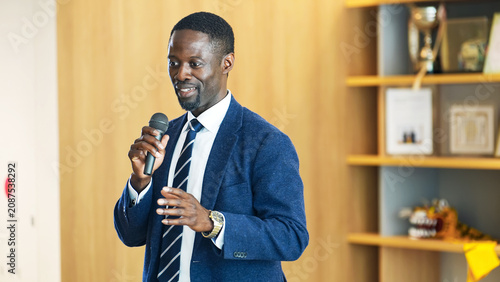 Obraz na płótnie A black man giving a speech in the lobby.