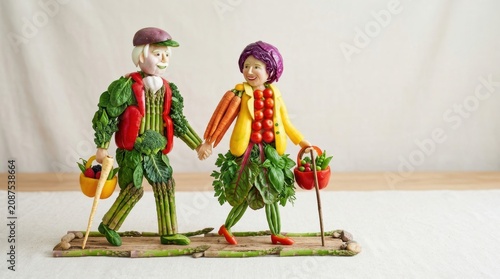 Colorful Clown Figures on Wooden Skis with Greenery Accessories.