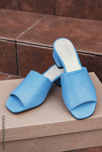 Elegant blue leather womens shoes blank product for branding displayed recyclable packaging. New casual female high heel sandals no-brand footwear e-commerce. No logo product unbranded fashion