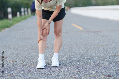 Foto Young adult female runner with knee pain from ACL injury or patellofemoral syndrome