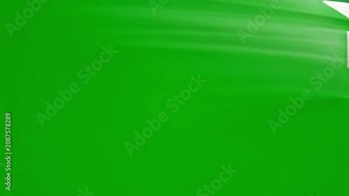 Closeup of White Paper Airplane Folding and Flying Against Bright Green Background