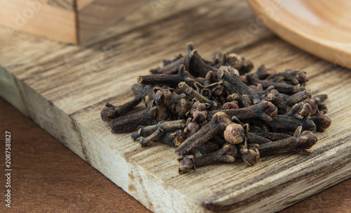 A handful of cloves on a cutting board