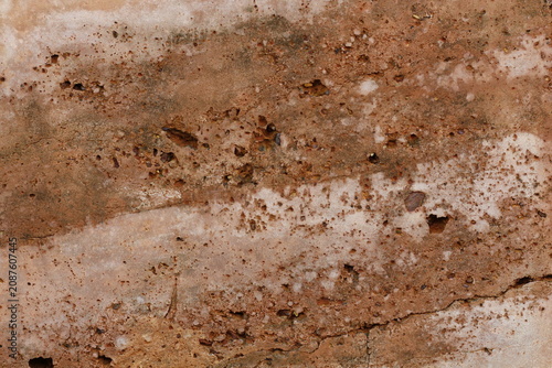 Принти на полотні Close-up texture of weathered natural stone with earthy tones and porous surface