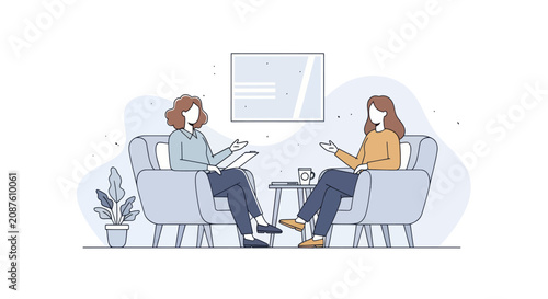 Two women talking in chairs during a therapy session.