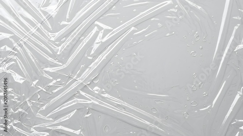 background with clear plastic wrap texture, wrinkled cellophane overlay, glossy reflections